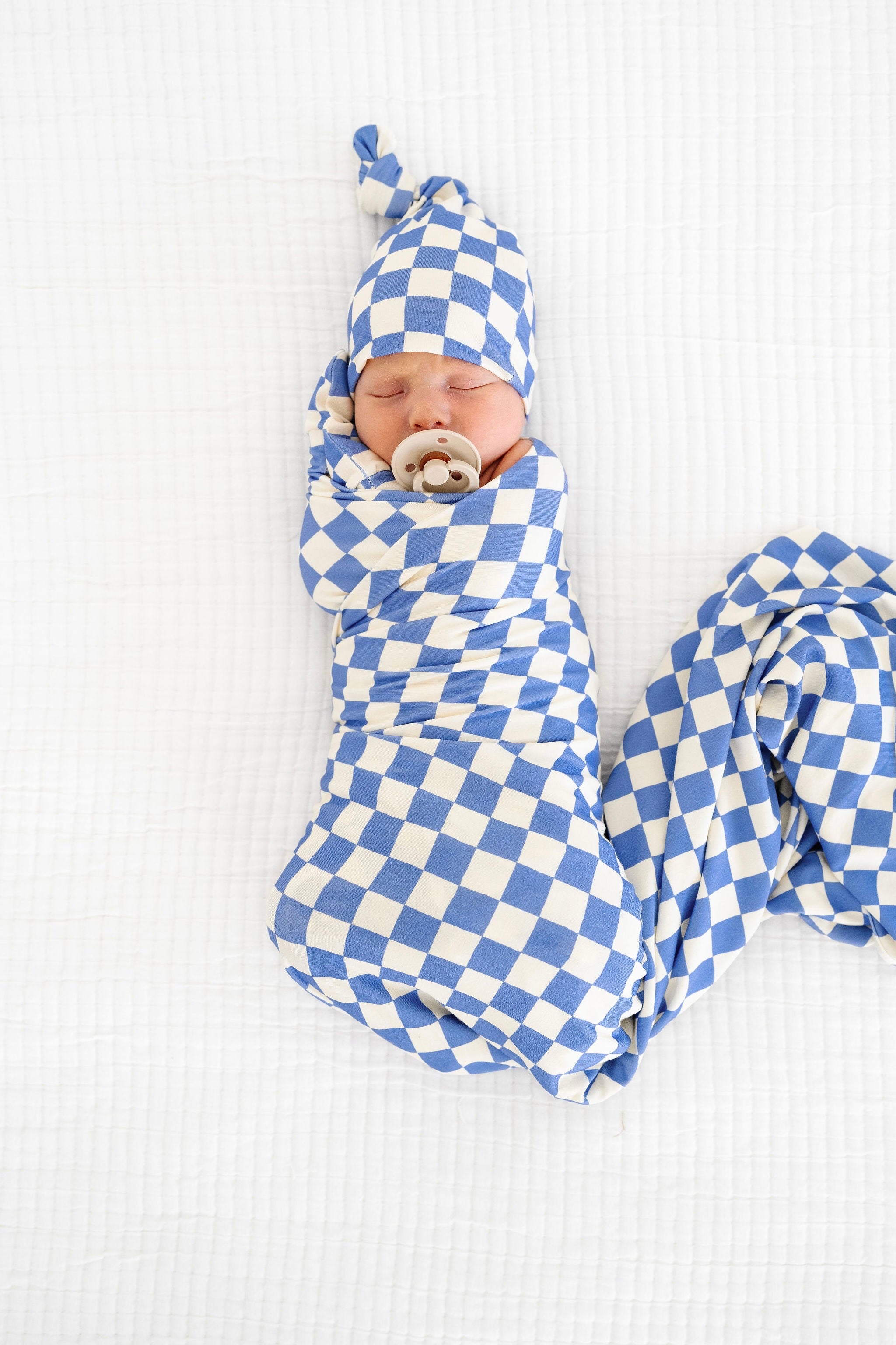 jett swaddle blanket with top knot hat newborn boy swaddles on bed
