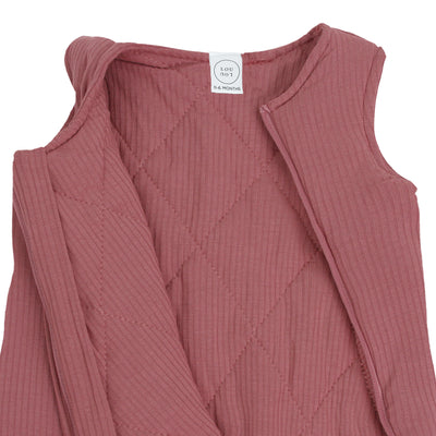 Pink ribbed baby dress with a brand label on a white background