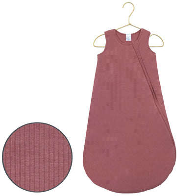 Pink baby sleeping bag with a close-up of texture on a white background