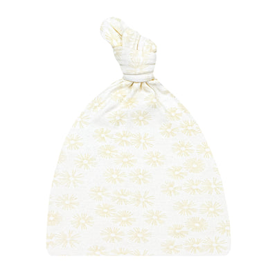 A beige top knot hat with a floral pattern
